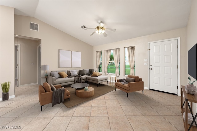 living room featuring ceiling fan, light tile patterned floors, and vaulted ceiling