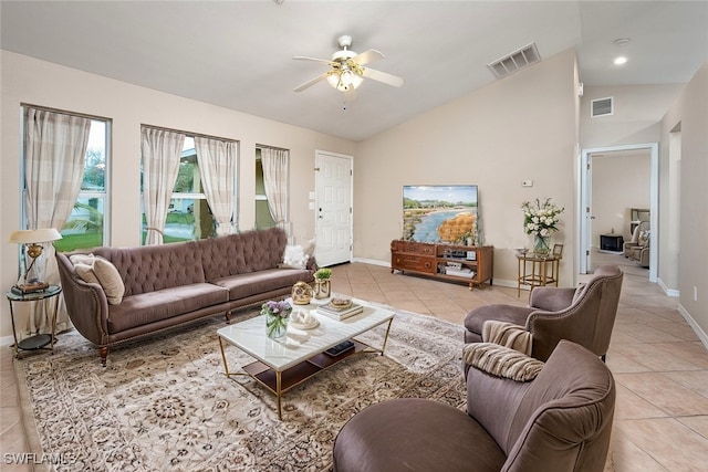 living room with vaulted ceiling, ceiling fan, and light tile patterned flooring