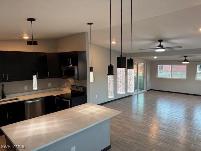 kitchen with ceiling fan, light wood-type flooring, stainless steel appliances, and hanging light fixtures