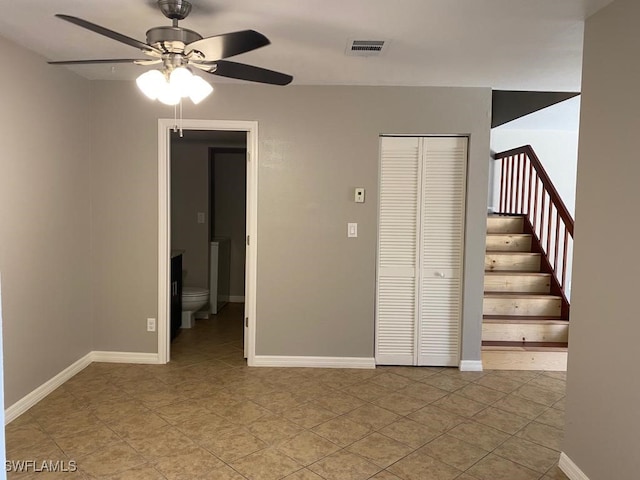 interior space with ceiling fan