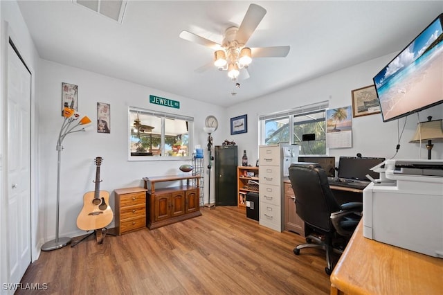 office with wood-type flooring and ceiling fan