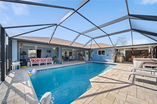 view of pool with glass enclosure, ceiling fan, and a patio