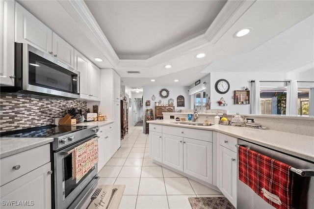 kitchen featuring plenty of natural light, white cabinets, stainless steel appliances, and sink