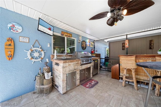 kitchen with ceiling fan, a sink, and refrigerator