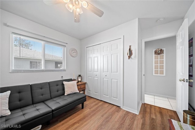 living room featuring hardwood / wood-style flooring and ceiling fan