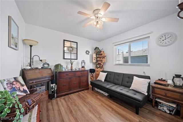 living room with ceiling fan and light wood-type flooring