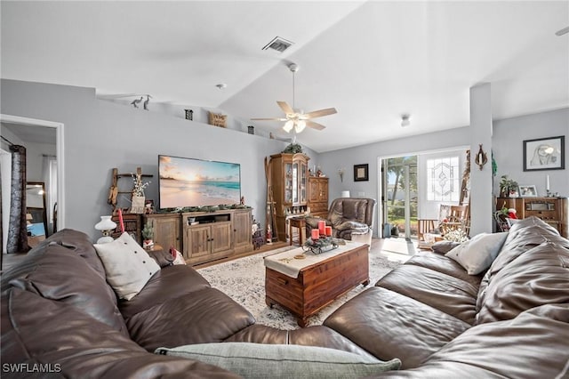 living room featuring ceiling fan and lofted ceiling