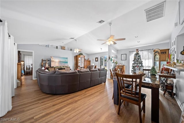 living room with ceiling fan, lofted ceiling, and hardwood / wood-style flooring