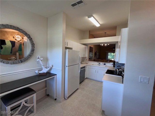 kitchen featuring white cabinetry, dishwasher, white fridge, and a notable chandelier