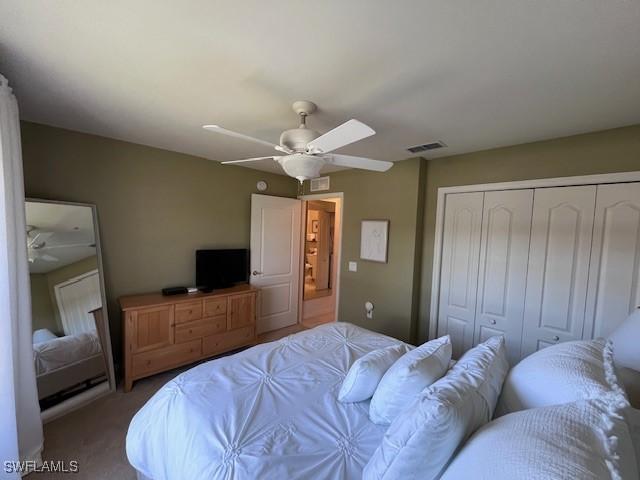 bedroom featuring carpet, a closet, and ceiling fan