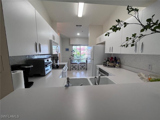 kitchen featuring white cabinets, white appliances, and sink