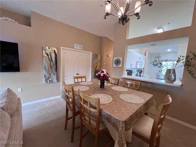 carpeted dining room featuring a chandelier