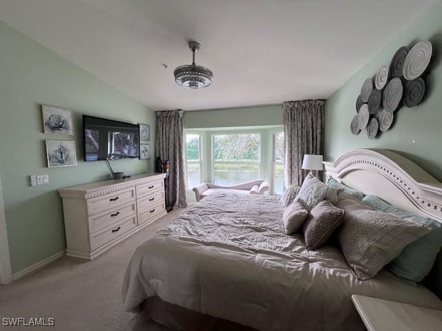 bedroom with lofted ceiling and light carpet