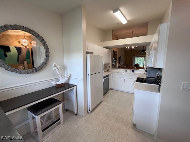 kitchen with white appliances, hanging light fixtures, light tile patterned floors, white cabinets, and an inviting chandelier