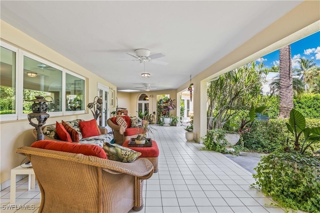 sunroom featuring french doors and ceiling fan