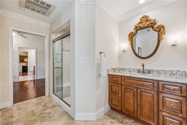 bathroom with ceiling fan, a shower with door, wood-type flooring, and crown molding