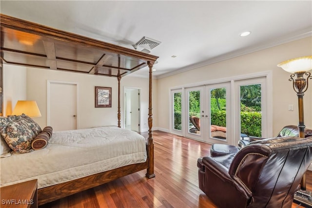 bedroom with access to exterior, wood-type flooring, crown molding, and french doors