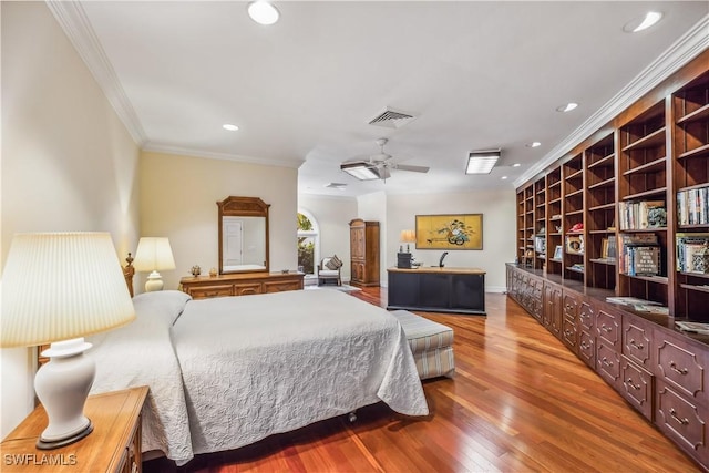 bedroom with crown molding, hardwood / wood-style floors, and ceiling fan