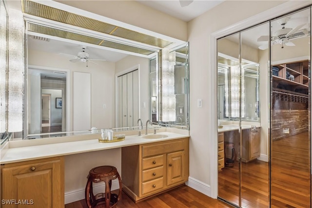 bathroom with vanity, ceiling fan, and wood-type flooring