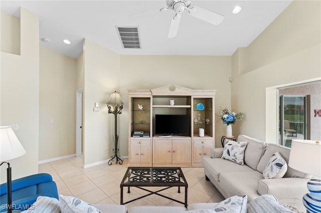 living room with ceiling fan and light tile patterned flooring