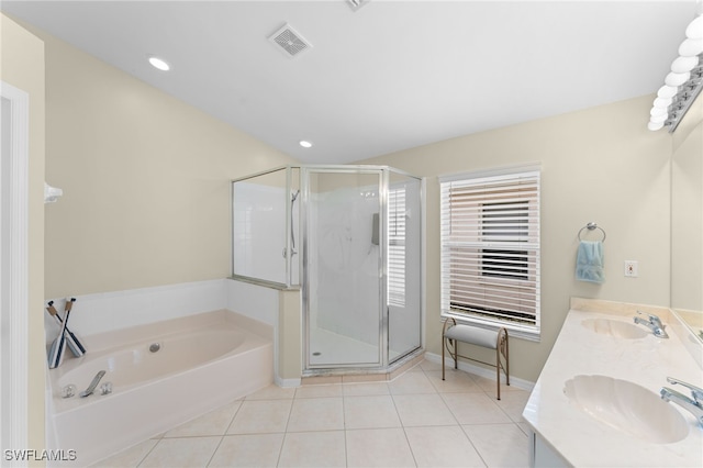 bathroom with tile patterned flooring, vanity, and separate shower and tub