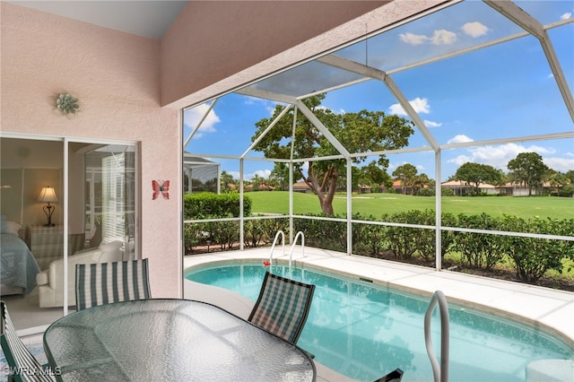 view of swimming pool with glass enclosure and a patio area