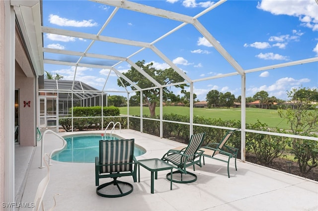 view of pool featuring glass enclosure and a patio area