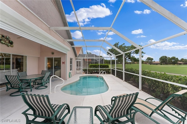 view of pool with a patio and a lanai