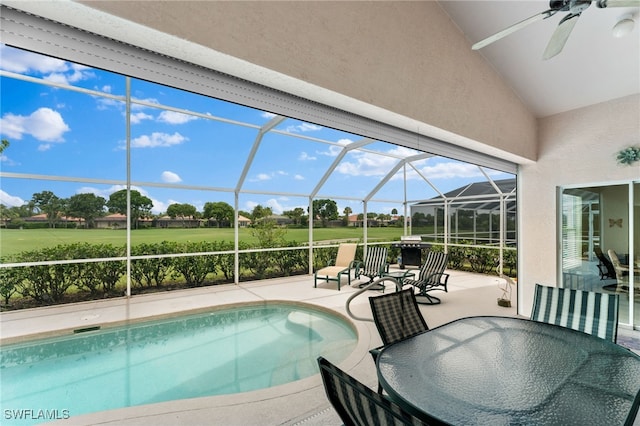 view of pool featuring a lanai, a patio area, and ceiling fan