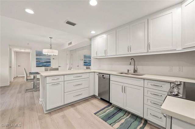 kitchen with stainless steel dishwasher, white cabinetry, and sink