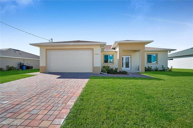 view of front of house with a front yard and a garage