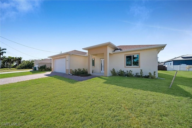 single story home featuring a garage and a front lawn