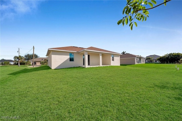 rear view of house with a lawn