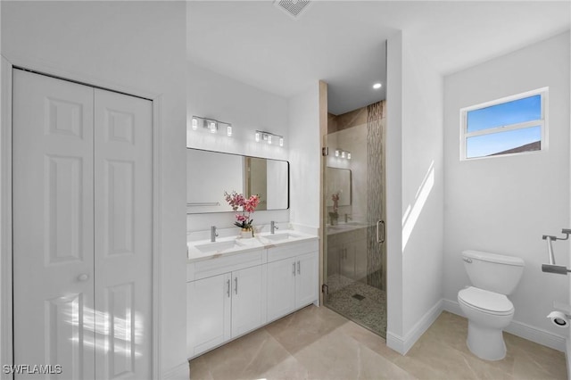 bathroom with an enclosed shower, vanity, toilet, and tile patterned floors