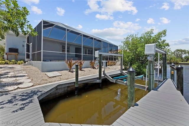 dock area with a water view, central AC, and a lanai