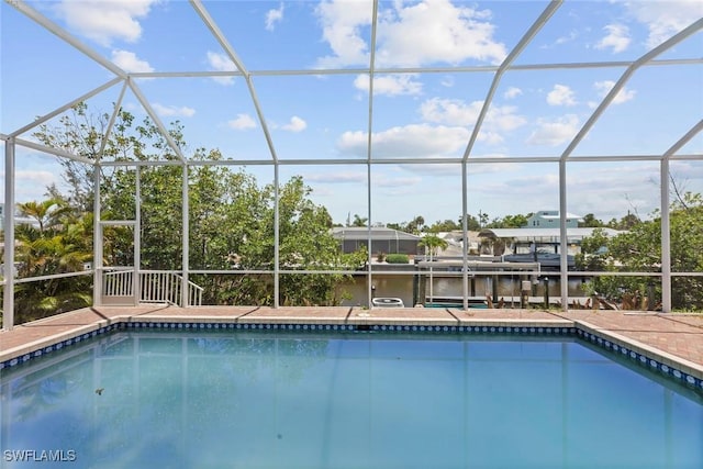 view of pool featuring a lanai and a water view