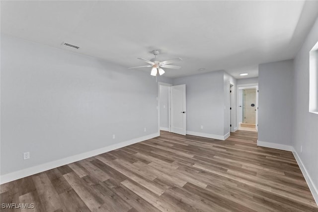 spare room with ceiling fan and wood-type flooring