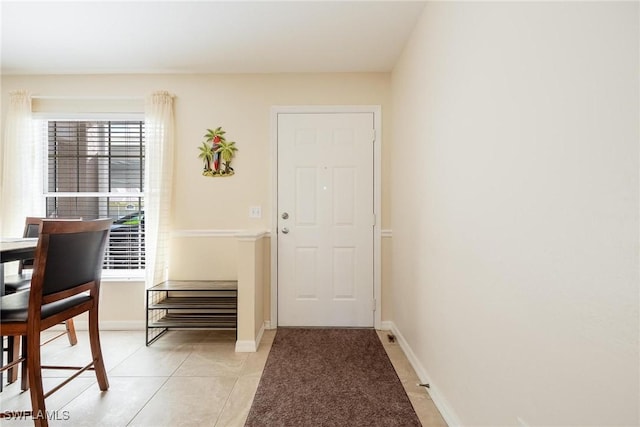 doorway to outside featuring light tile patterned floors