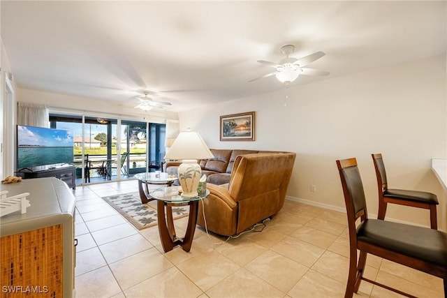 living room with ceiling fan and light tile patterned flooring