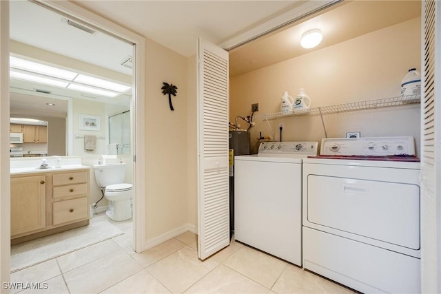 laundry room featuring light tile patterned floors and washing machine and clothes dryer