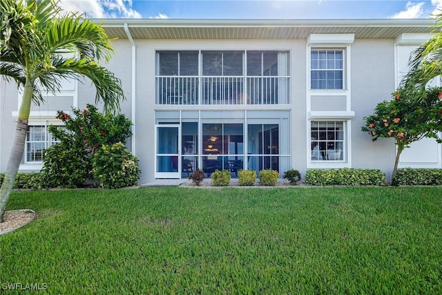 rear view of property with a yard