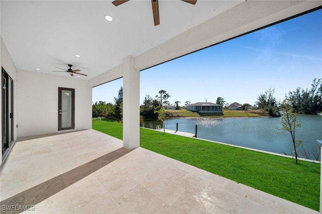 view of patio featuring ceiling fan and a water view