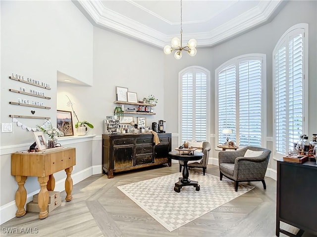 living area featuring a chandelier, a raised ceiling, plenty of natural light, and crown molding