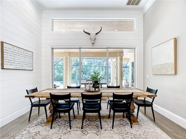 dining room featuring hardwood / wood-style flooring and ornamental molding