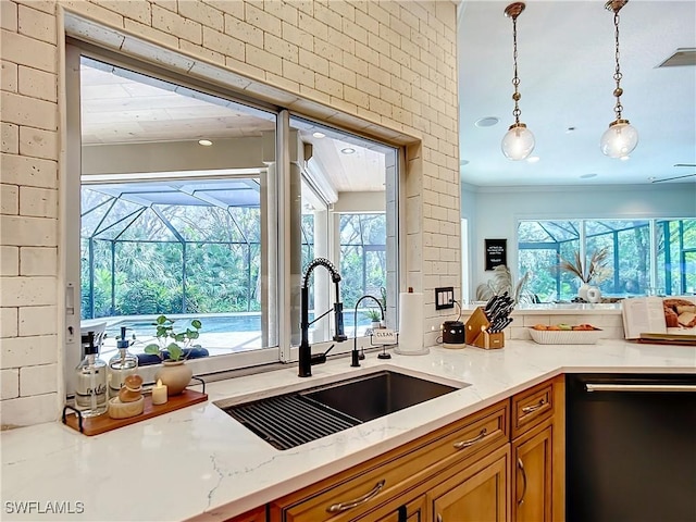 kitchen with pendant lighting, black dishwasher, a healthy amount of sunlight, and sink