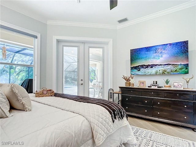 bedroom with light hardwood / wood-style floors, access to exterior, multiple windows, and french doors