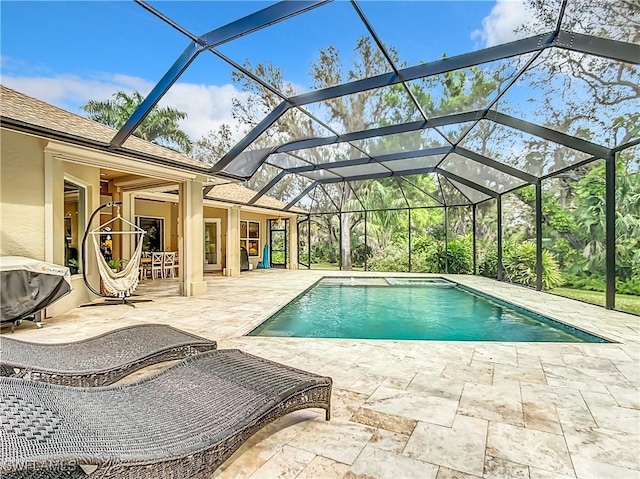 view of swimming pool with a lanai, a patio area, and a grill