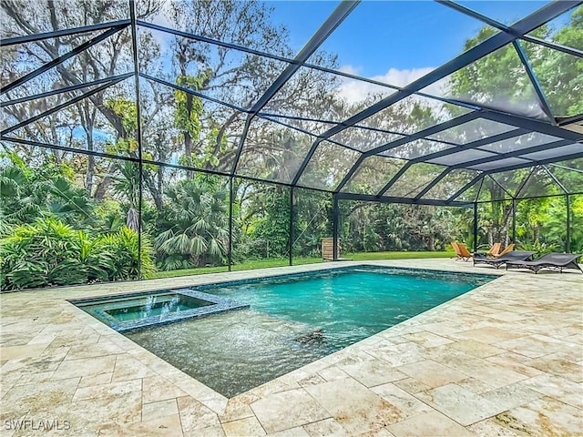 view of swimming pool with an in ground hot tub, glass enclosure, and a patio area