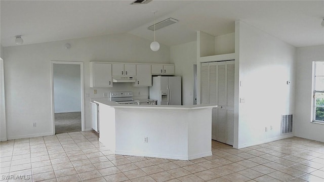 kitchen with lofted ceiling, light tile patterned floors, white appliances, and decorative light fixtures