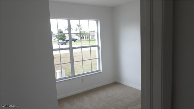 carpeted empty room with a healthy amount of sunlight